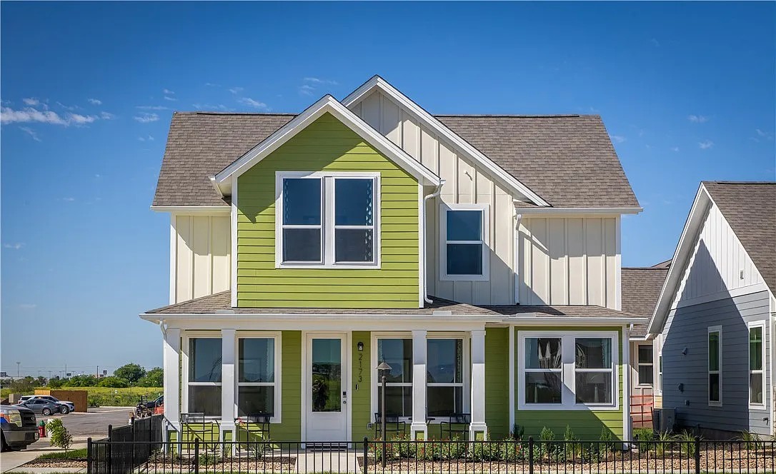 Brightly painted cottage exterior with white trim and covered porch