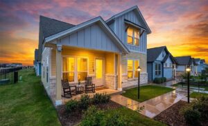 Cottage style homes in 2026: a painted cottage exterior with a covered front porch at Garten Haus in New Braunfels, Texas